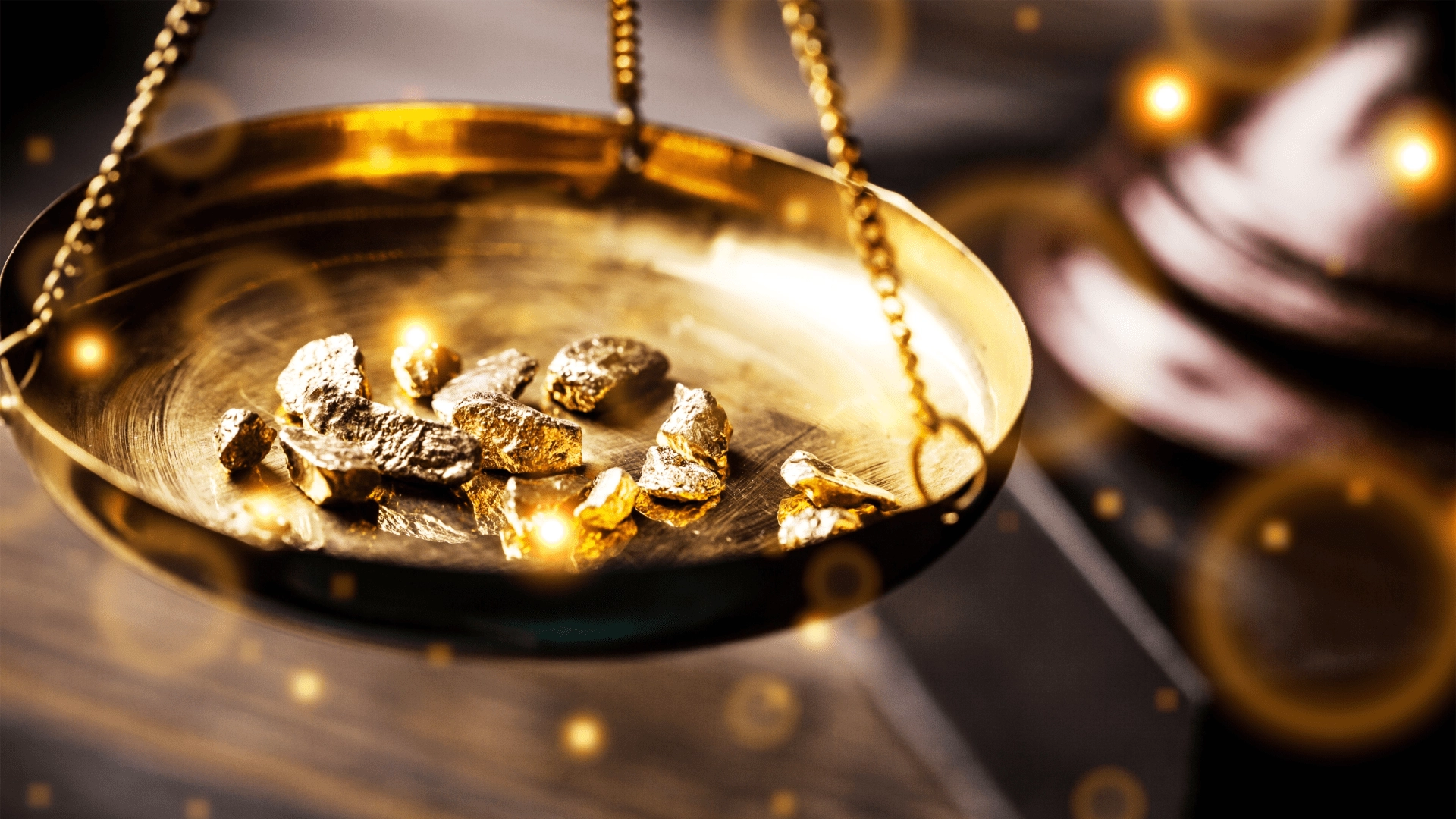gold on the weighing scale, representing gold prices and mass